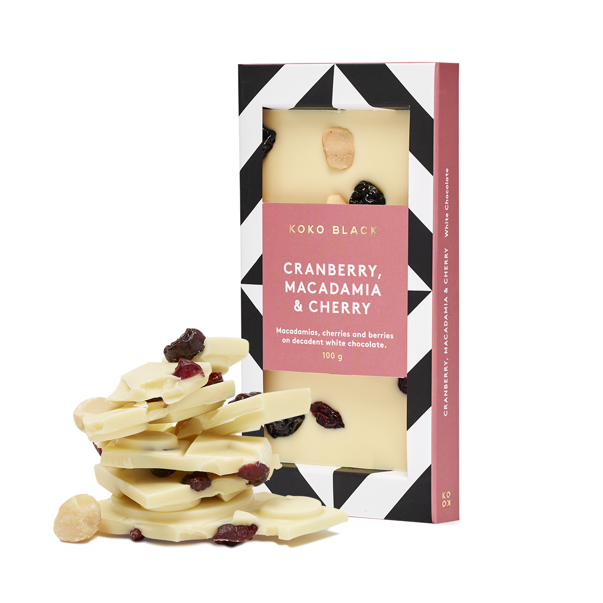 Broken white chocolate beside packaged chocolate block