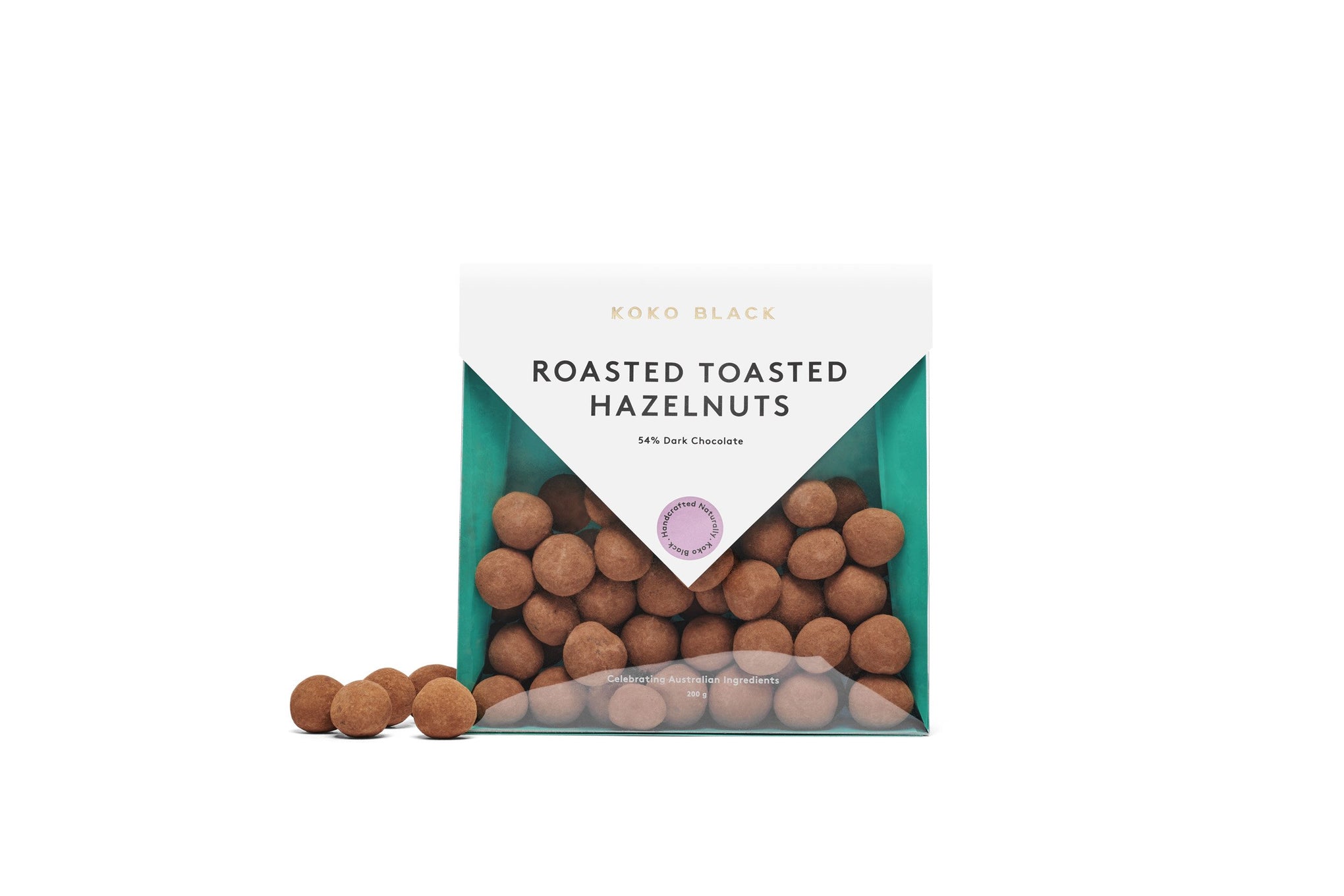 Dusted chocolate hazelnuts beside packaging