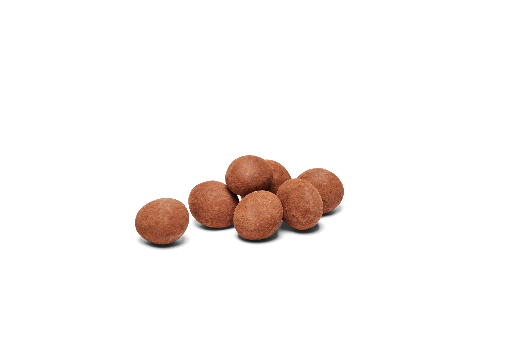 Chocolate dusted hazelnuts placed together