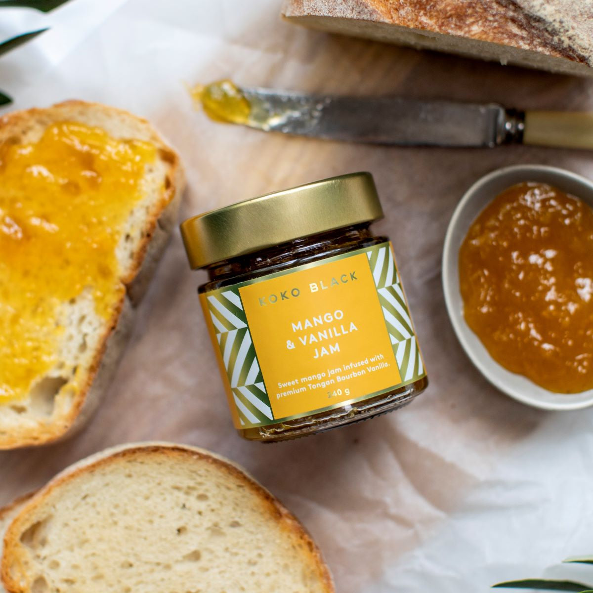 Jar surrounded by toast, butter knife and spread